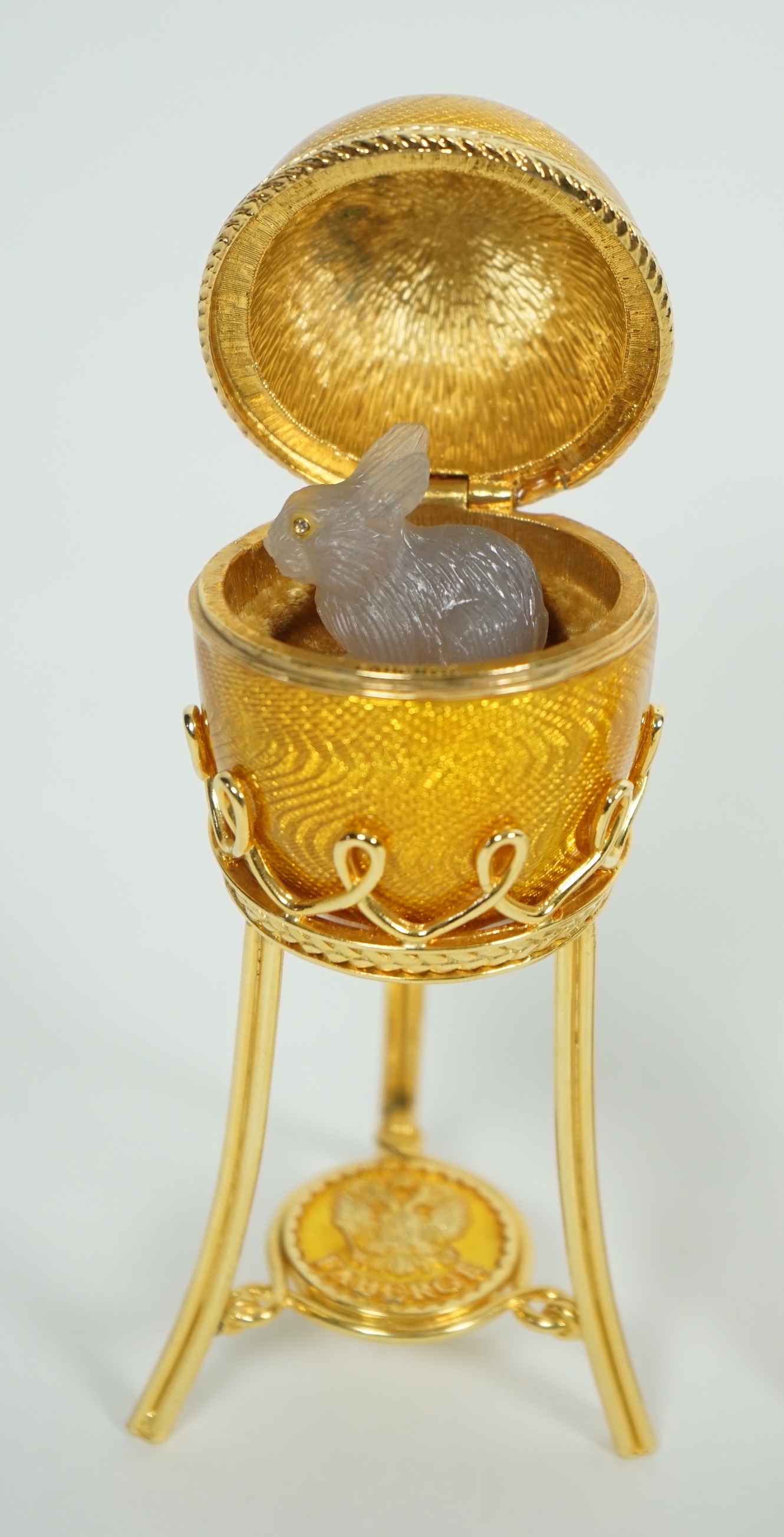 A Fabergé Imperial Collection Menagerie Rabbit Surprise Egg on stand together with a Fabergé gilt and enamel photograph frame